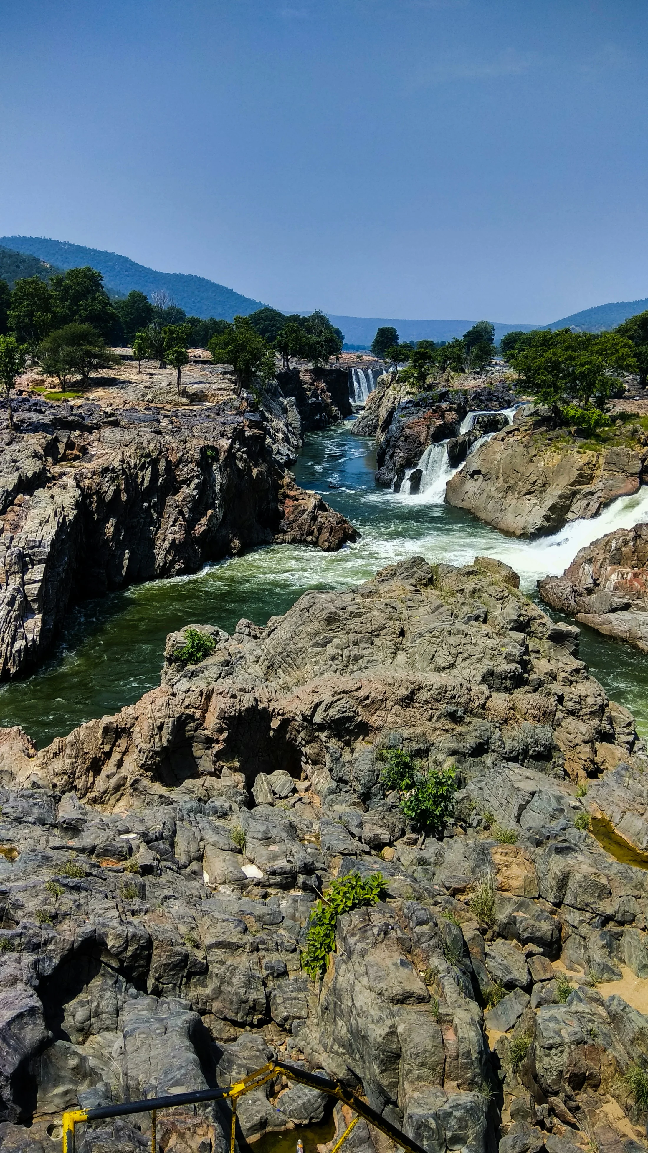 The Kaveri river falling in white channels through a gorge of dark, water-worn rock at Hogenakkal