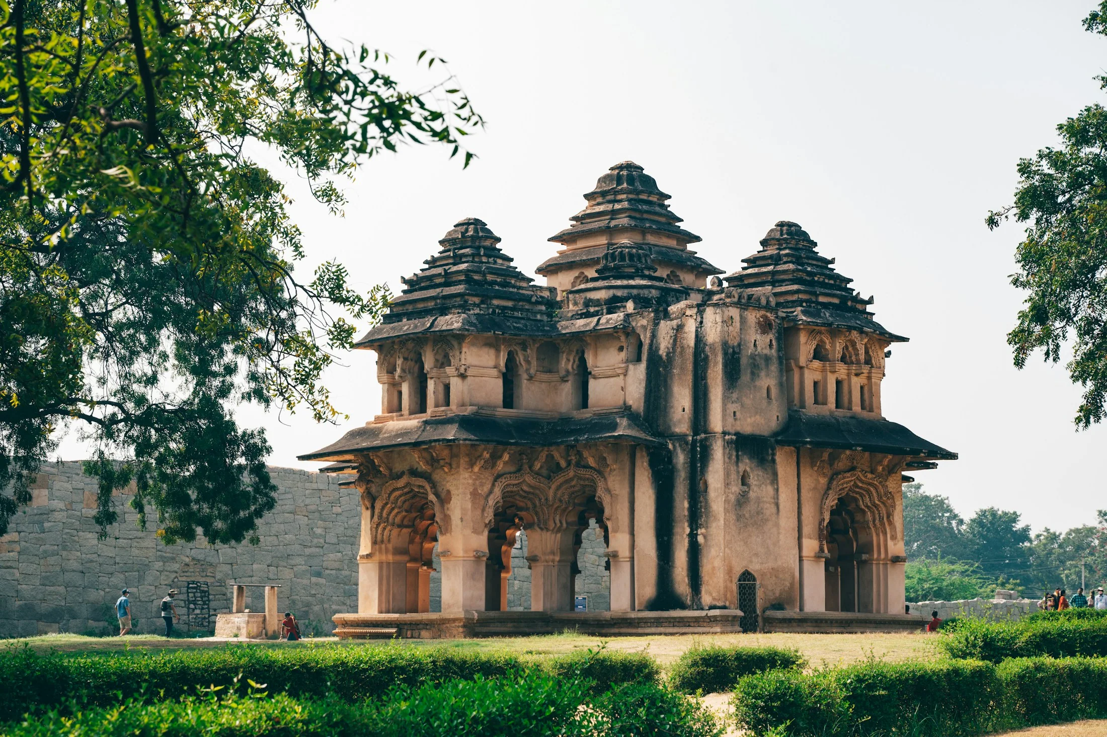 The arched, tiered Lotus Mahal standing among the ruins at Hampi