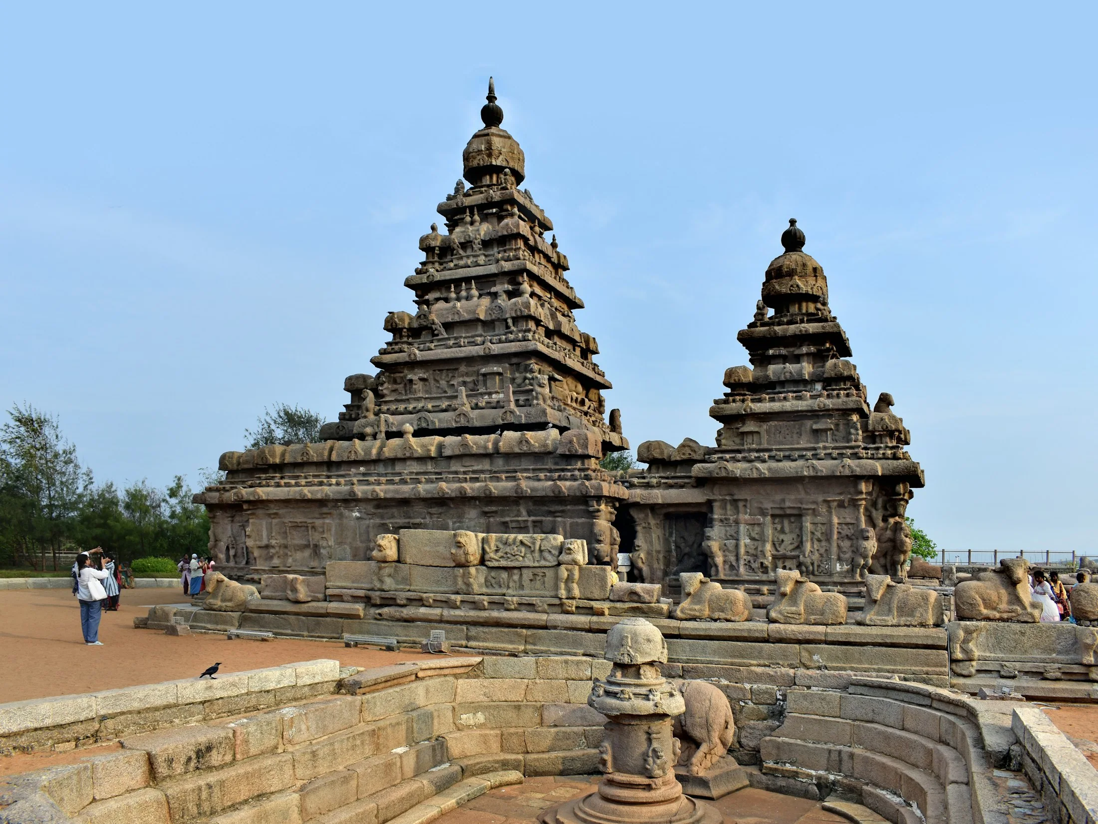 The stepped granite towers of the Shore Temple at Mahabalipuram standing beside the Bay of Bengal